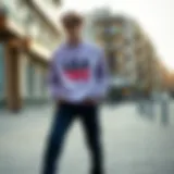 Lila sweatshirt styled with casual pants and sneakers in urban setting