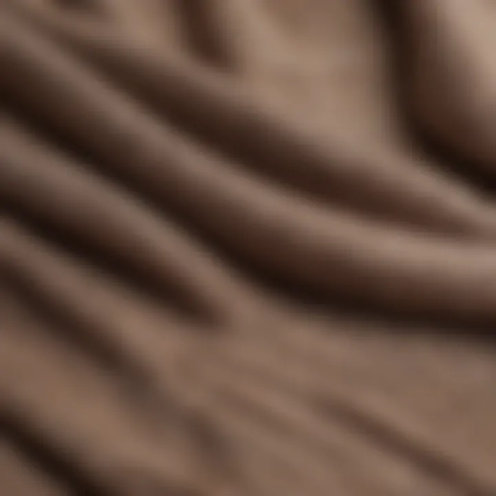 A close-up detail of the fabric texture of a taupe sweater, highlighting its quality.